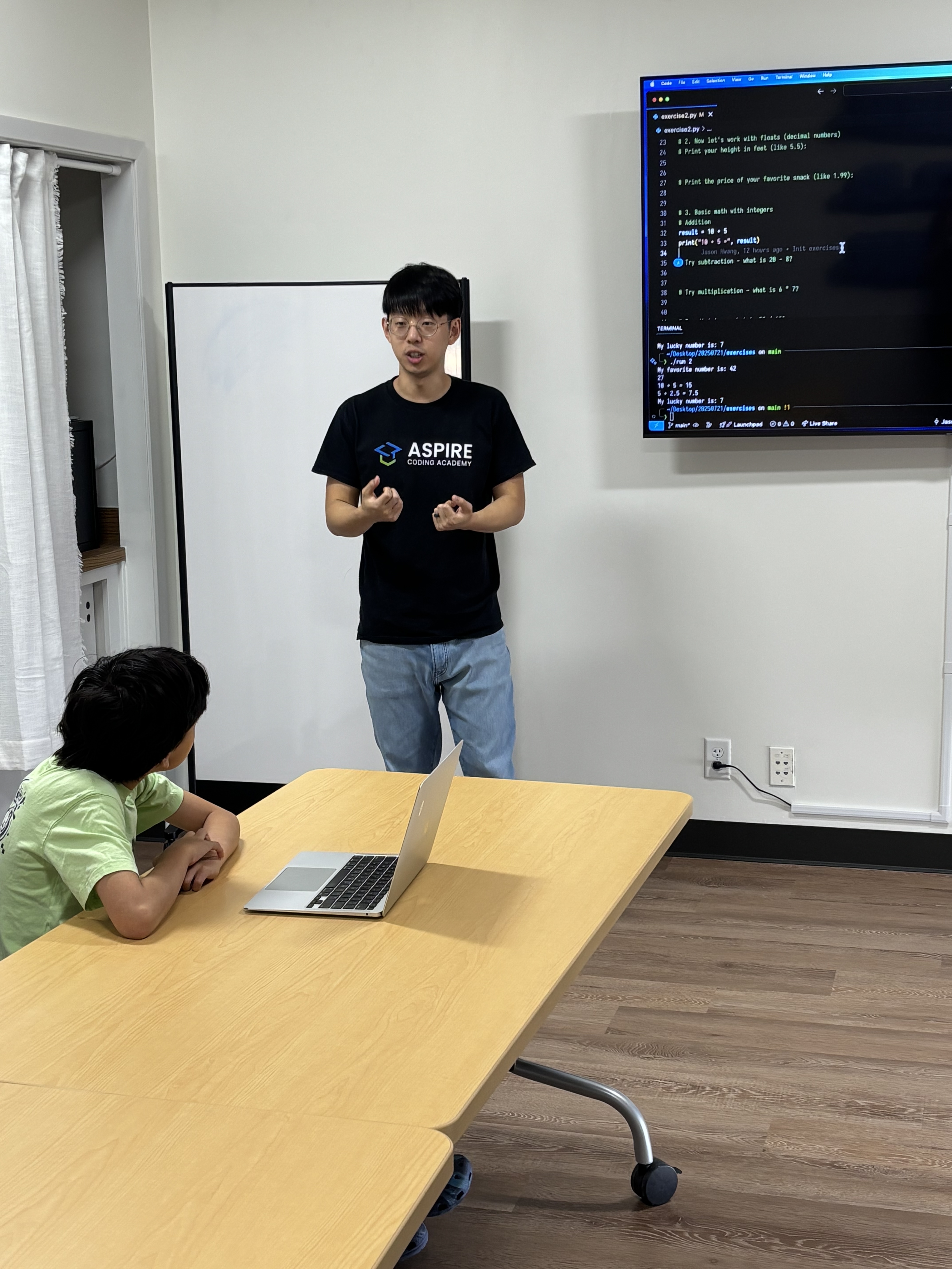 Jason teaching coding to a student one-on-one.